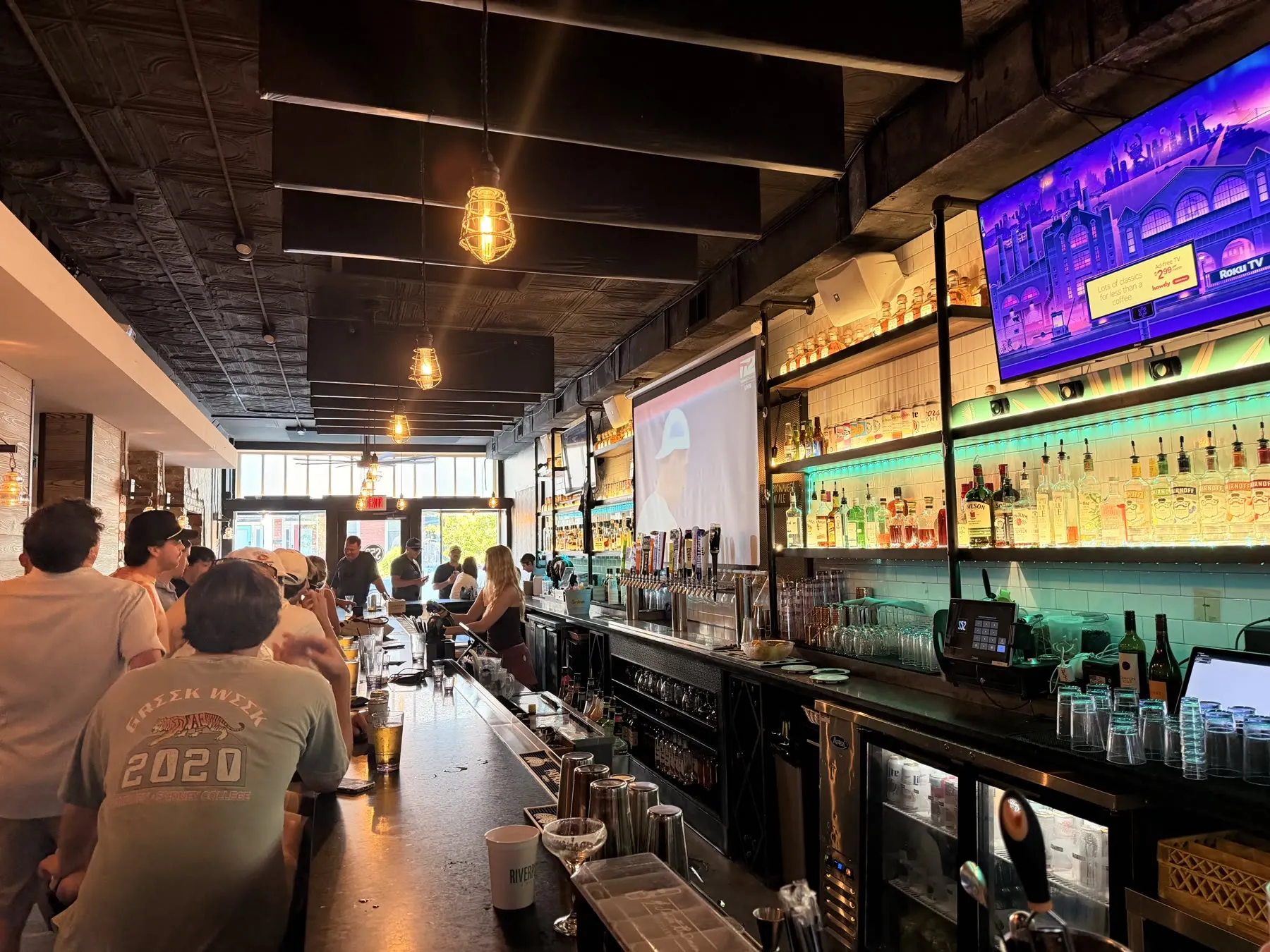 A crowded view down the Social 52 bar